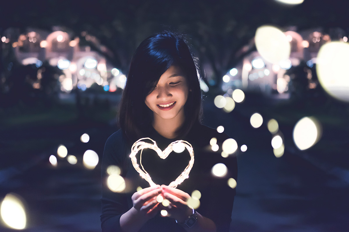 woman looking at a light up heart