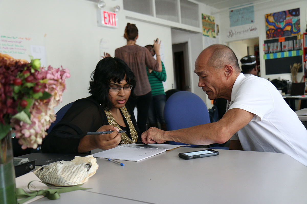 man helping a woman write