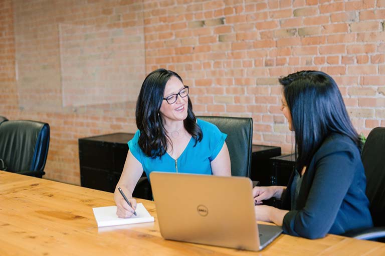 to women discussing over a computer