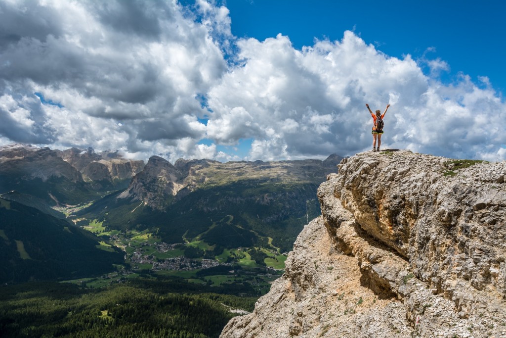 person stood on a cliff with a great view, a corporate alumni program metaphor