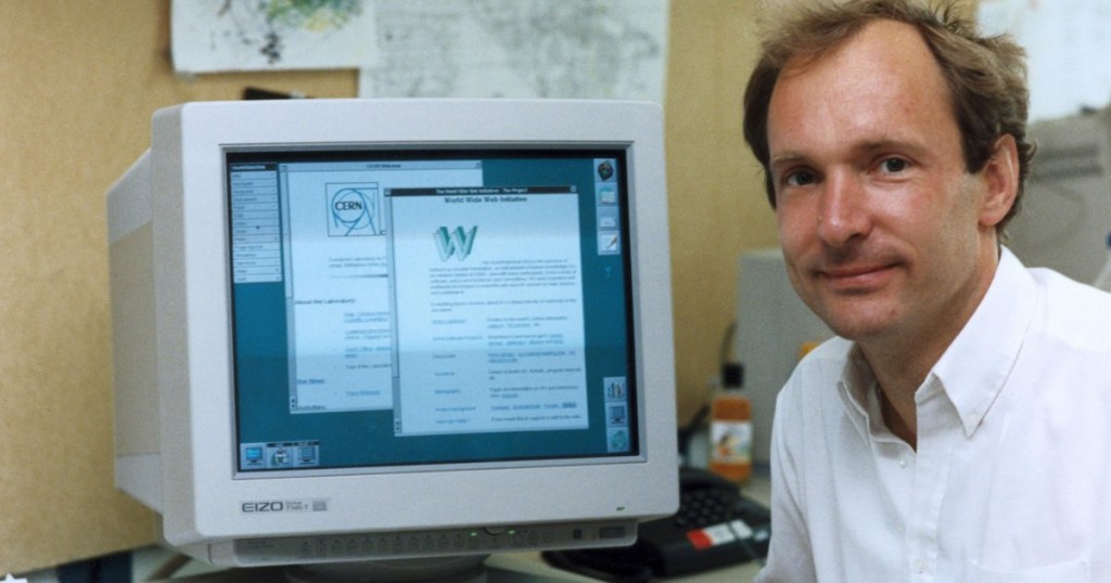 Tim berners lee with an early digital community on his screen