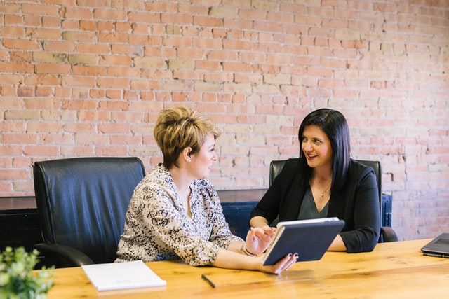 two women discussing their online mentorship in person