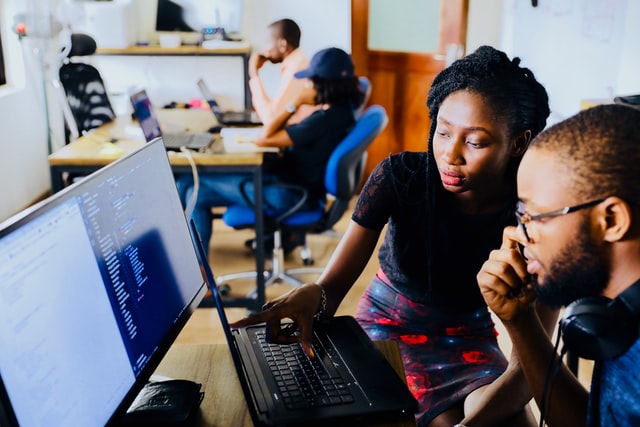 two people looking at the computer with an online mentorship 