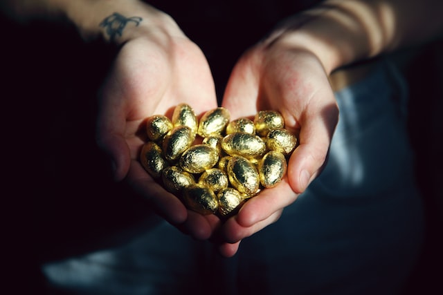 small golden eggs in hands