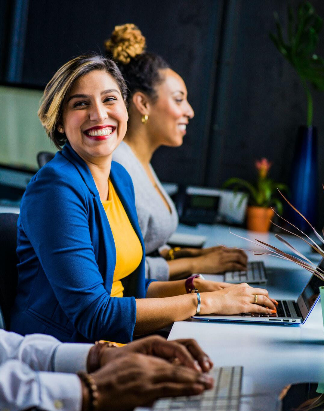 woman laughing on a laptop