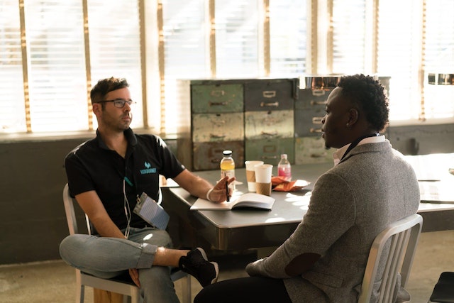 two men talking about employee referrals at a boomerang employee interview