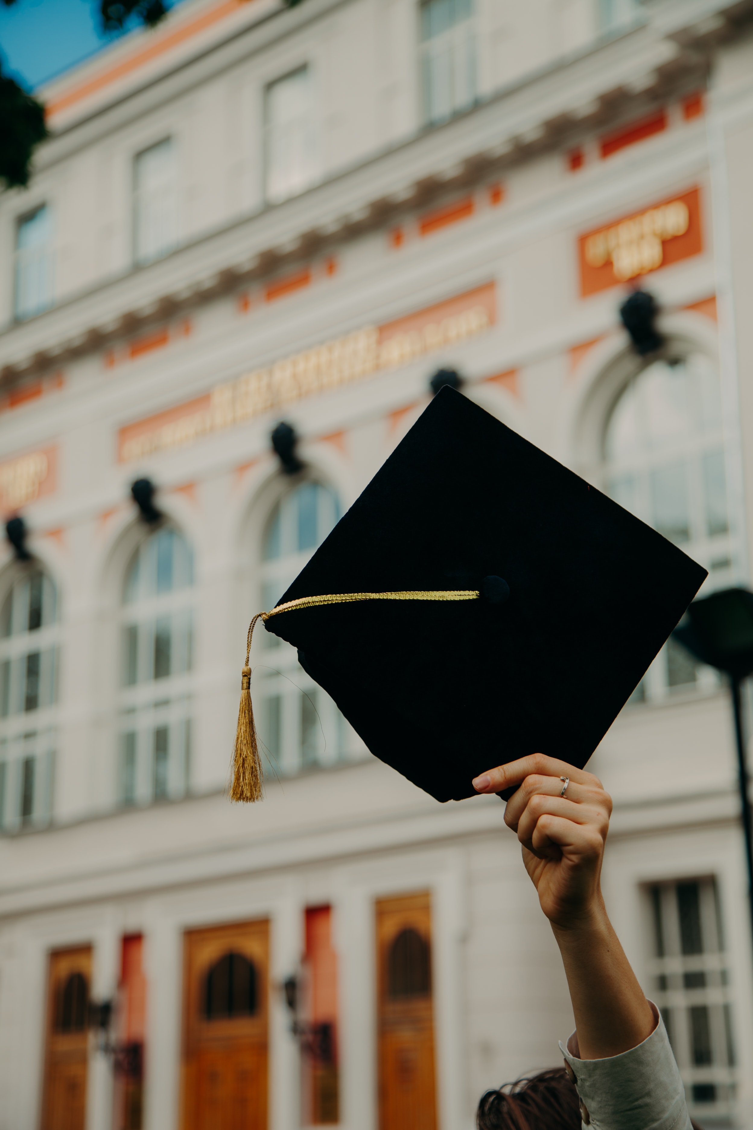 a man throwing a hat in the air after participating in alumni engagement software to help his studies